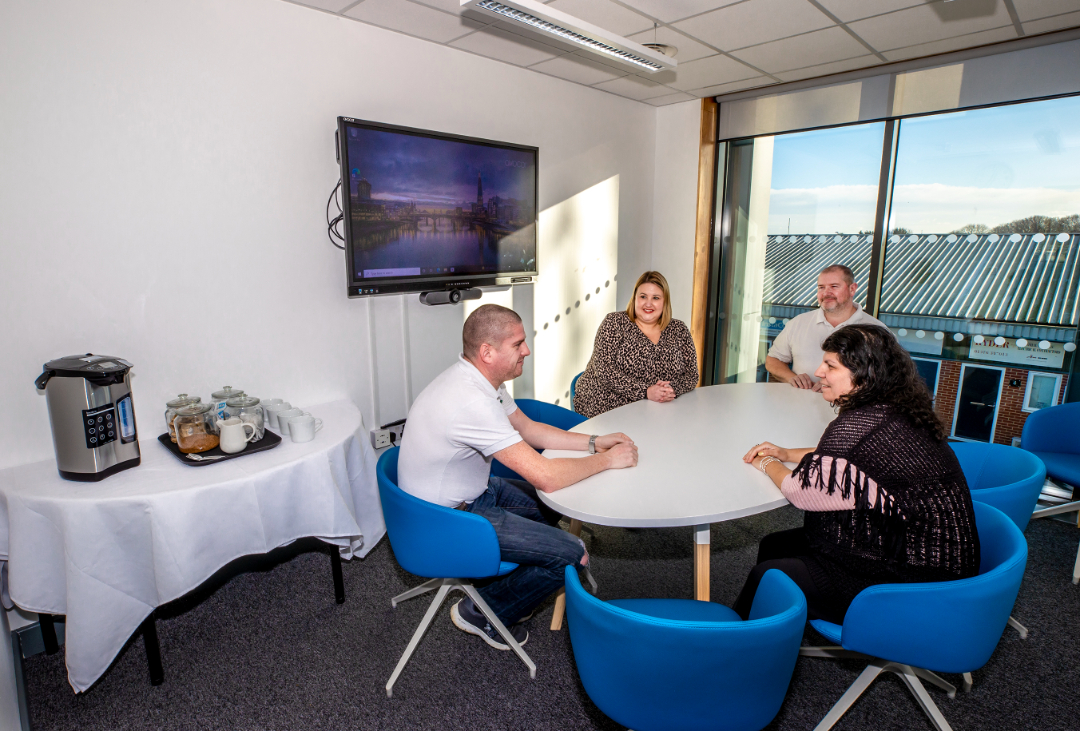 Small meeting room with people in 