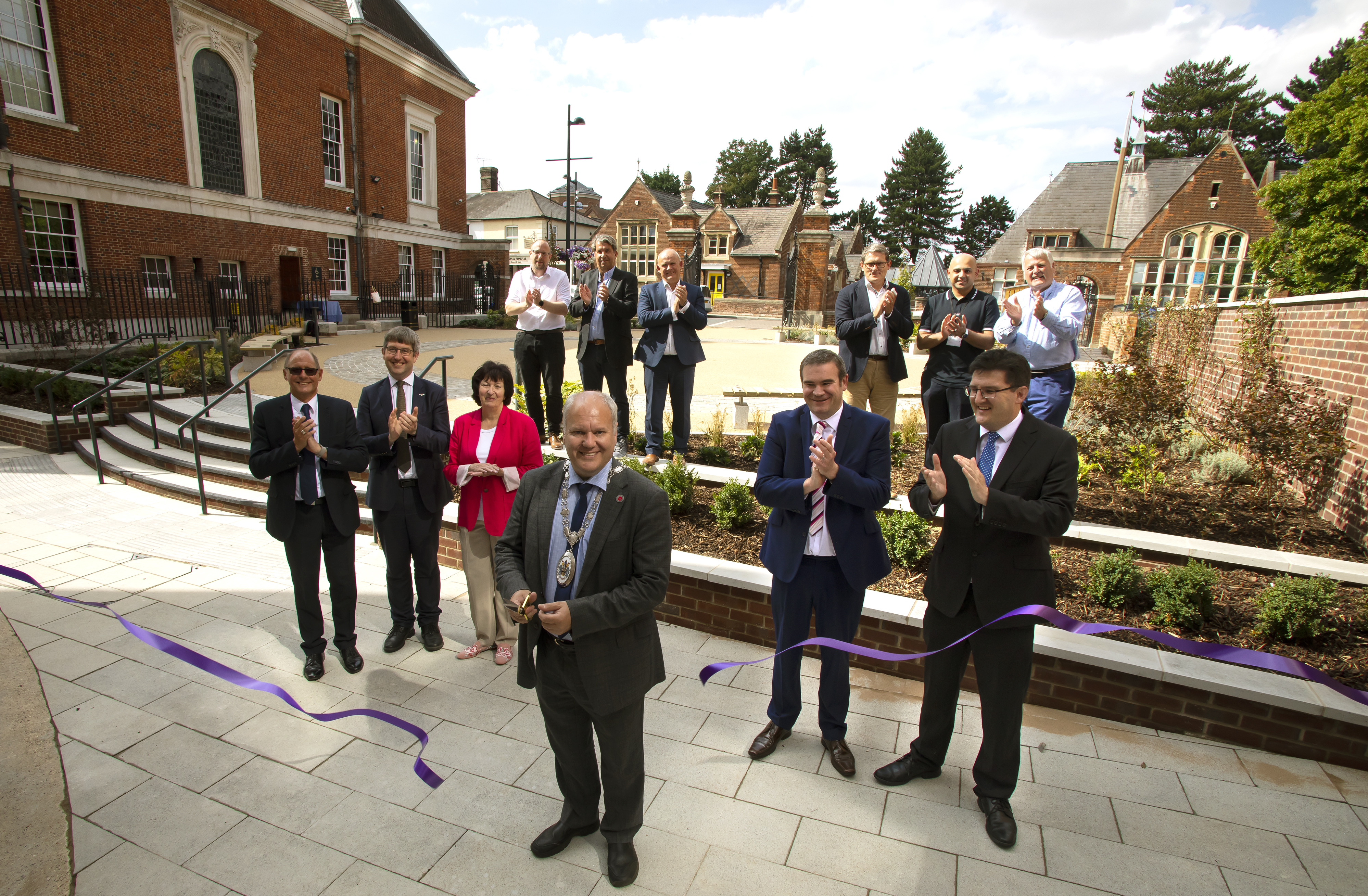 Chairman Cllr Andrew Hensman cutting the ribbon at the garden behind the Town Hall