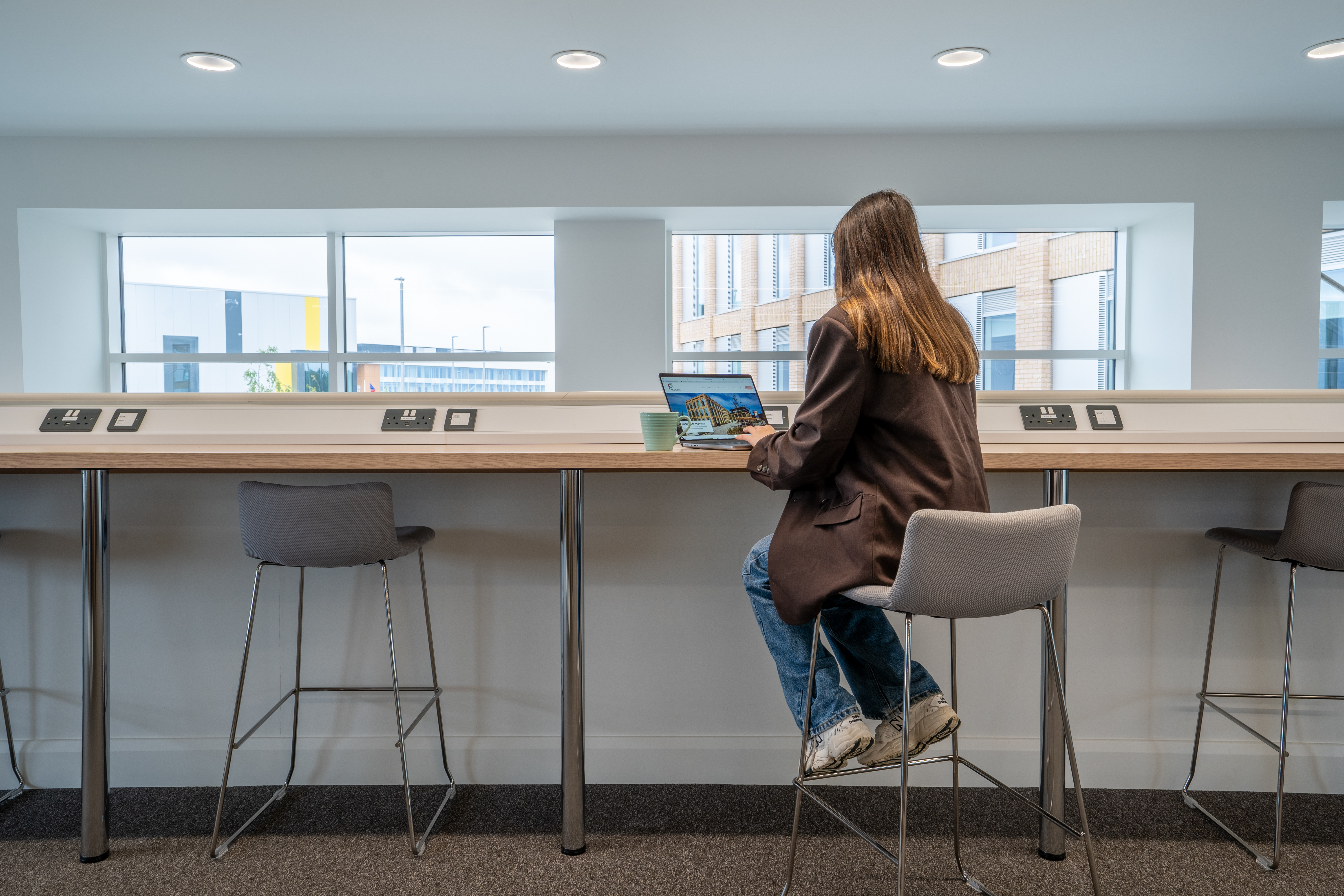 A person sitting at a coworking desk