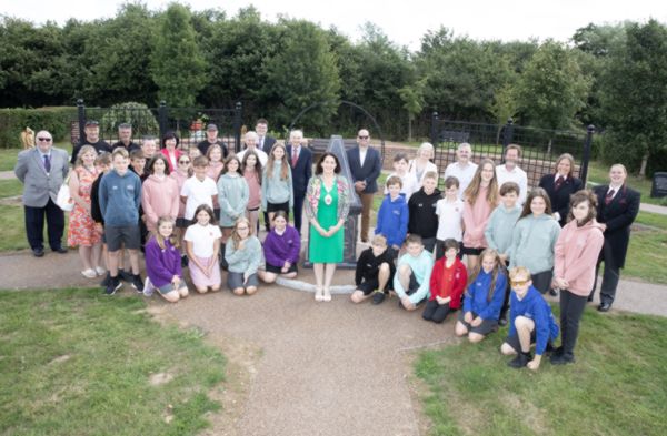 A photo of people stood in a memorial garden