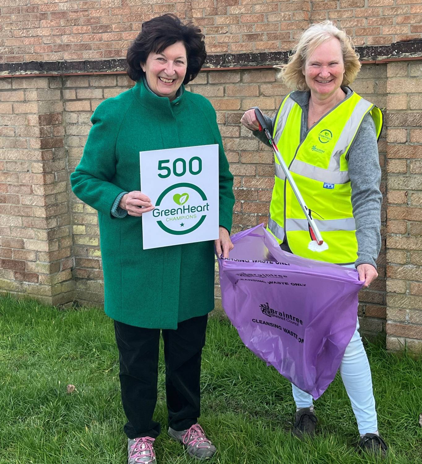 green heart champion 500th volunteer wearing high visibility jacket, litter picker and trash bag