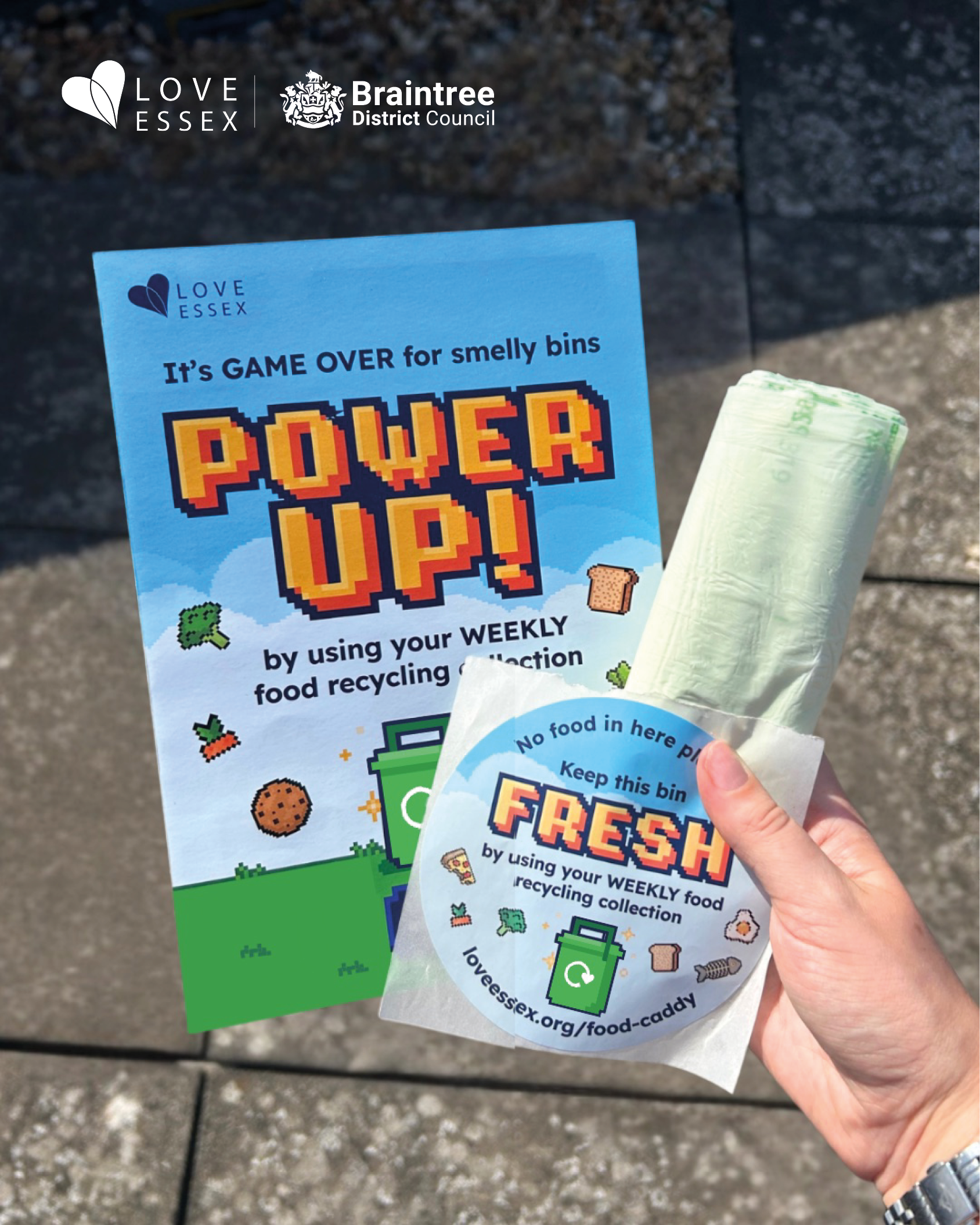 Hand holding leaflet, caddy liners, and a sticker. The leaflet says, “power up by using your weekly food recycling collection”. Text says "latest, households to receive help recycling food as part of Power Up campaign".