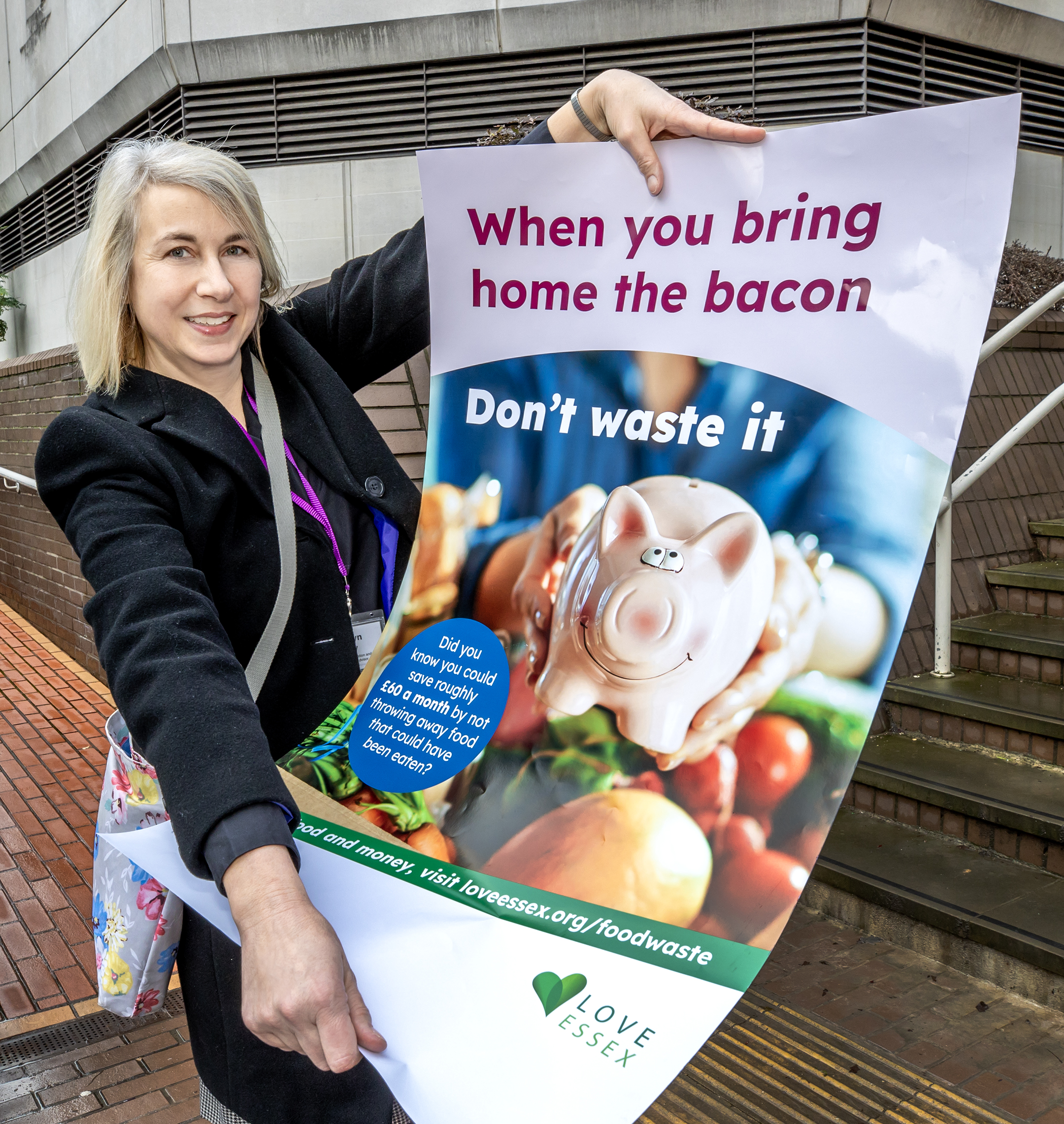 image shows BDC waste minimisation and sustainability team member holding a campaign poster