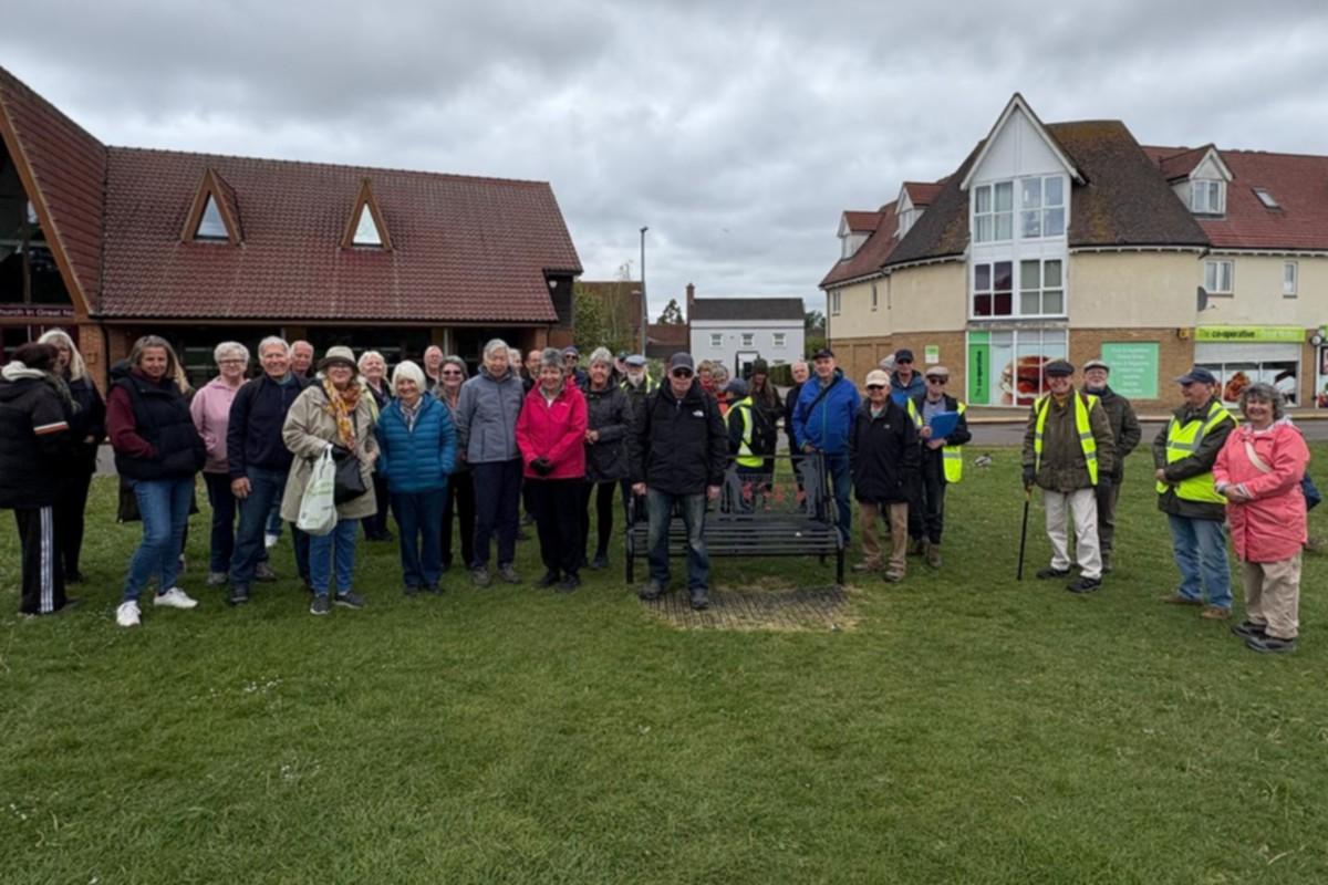 Braintree walking group standing on the green in front of shops