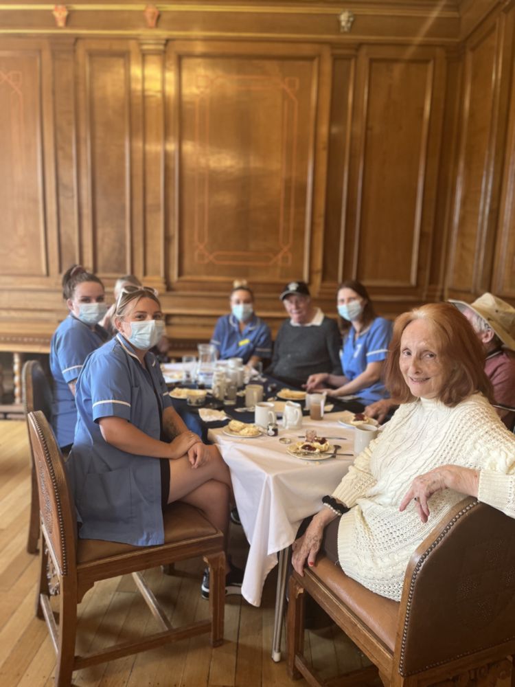 Photo of group of people sat round a desk