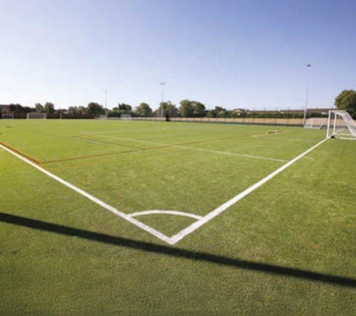 Photo from a corner of a green football pitch looking inward