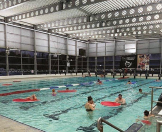 People playing and swimming in the leisure centre pool