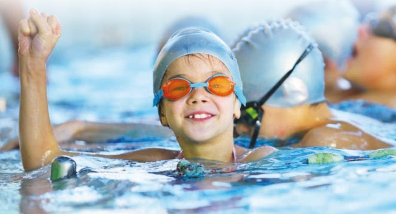 A child swimming, wearing goggles