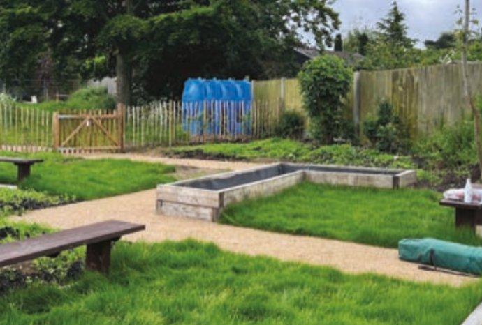 example of a community garden project showing grass, benches and a pathway