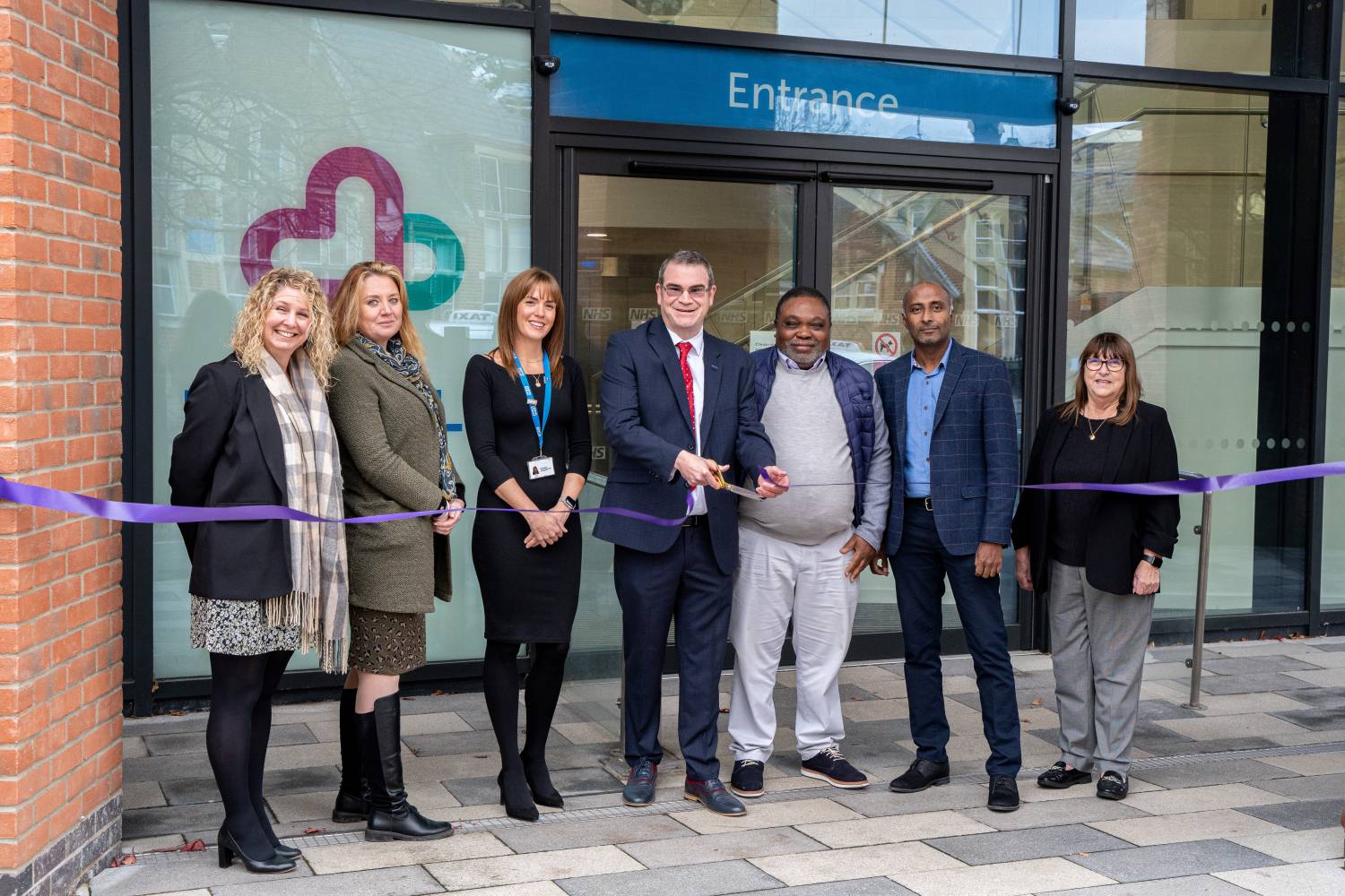 Councillors and representatives from the NHS cutting a ribbon at the Live Well hub