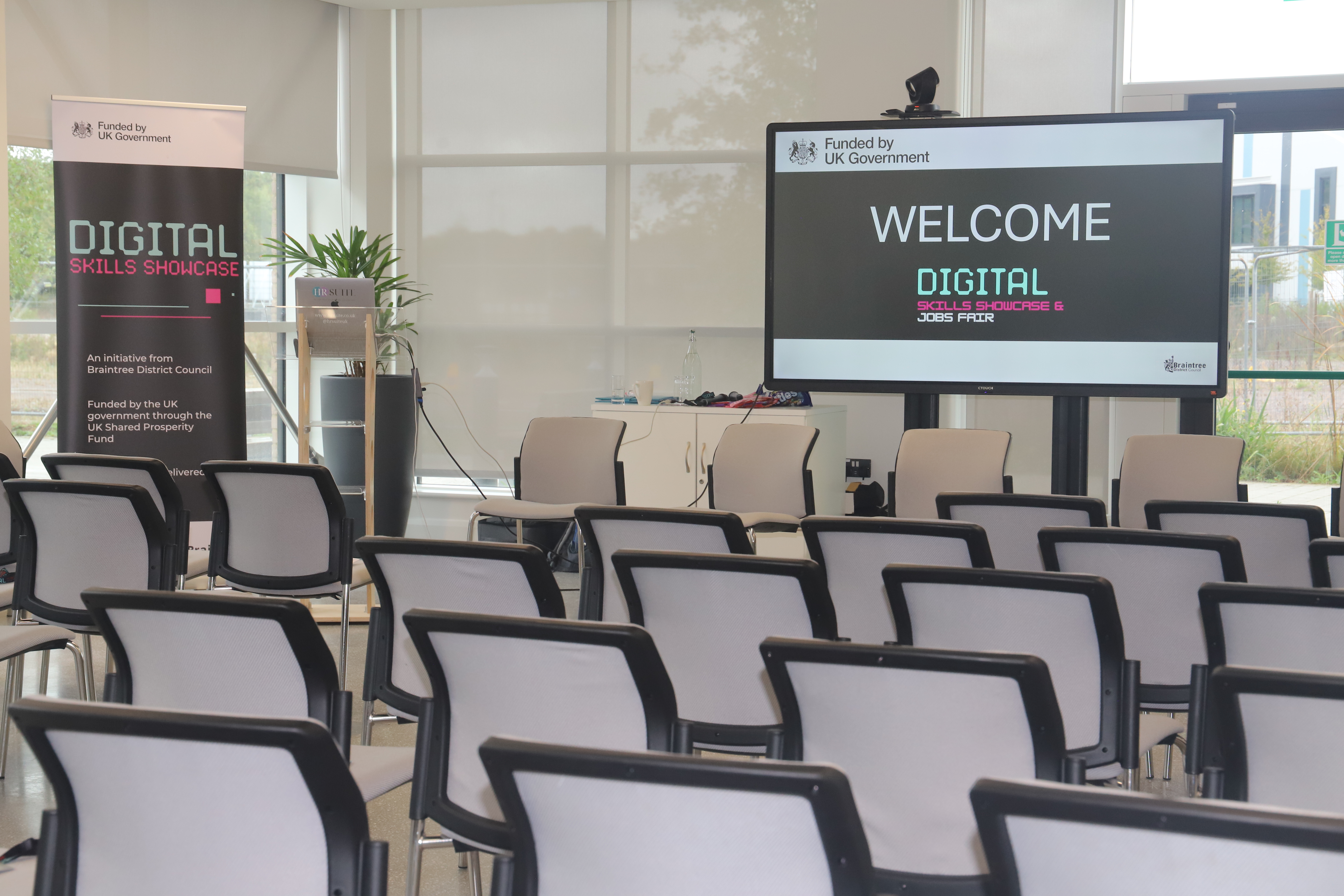 The image shows a rage of chair facing a screen at the front