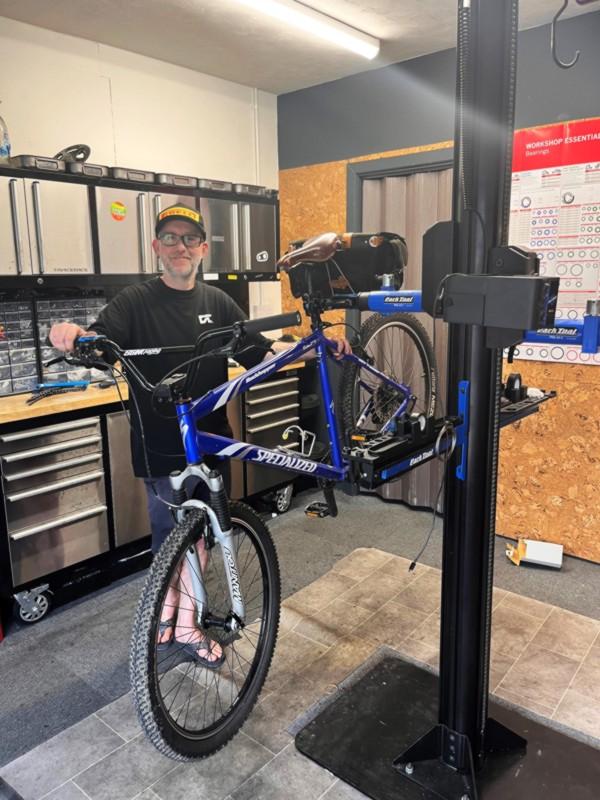 Doer cycles workshop with bike mounted in racking