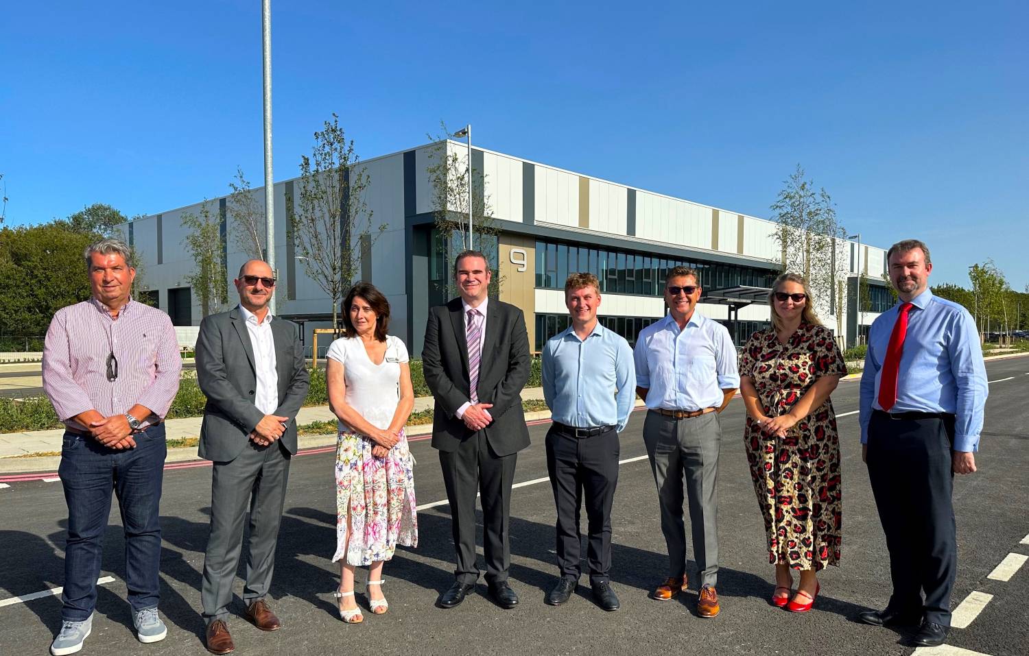 Councillors and officers standing in front of a commercial unit