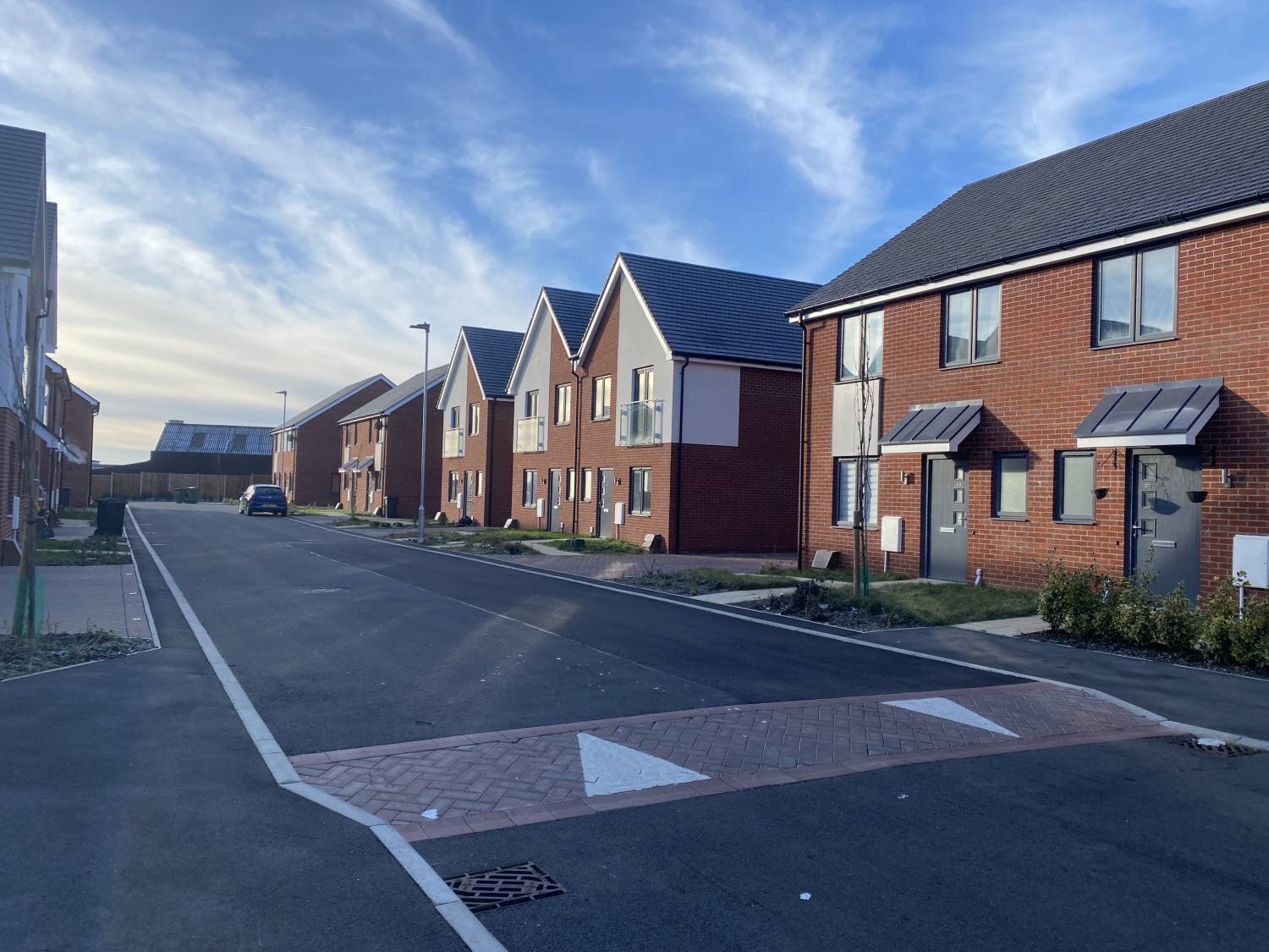 Photos of a row of houses with a road - Image