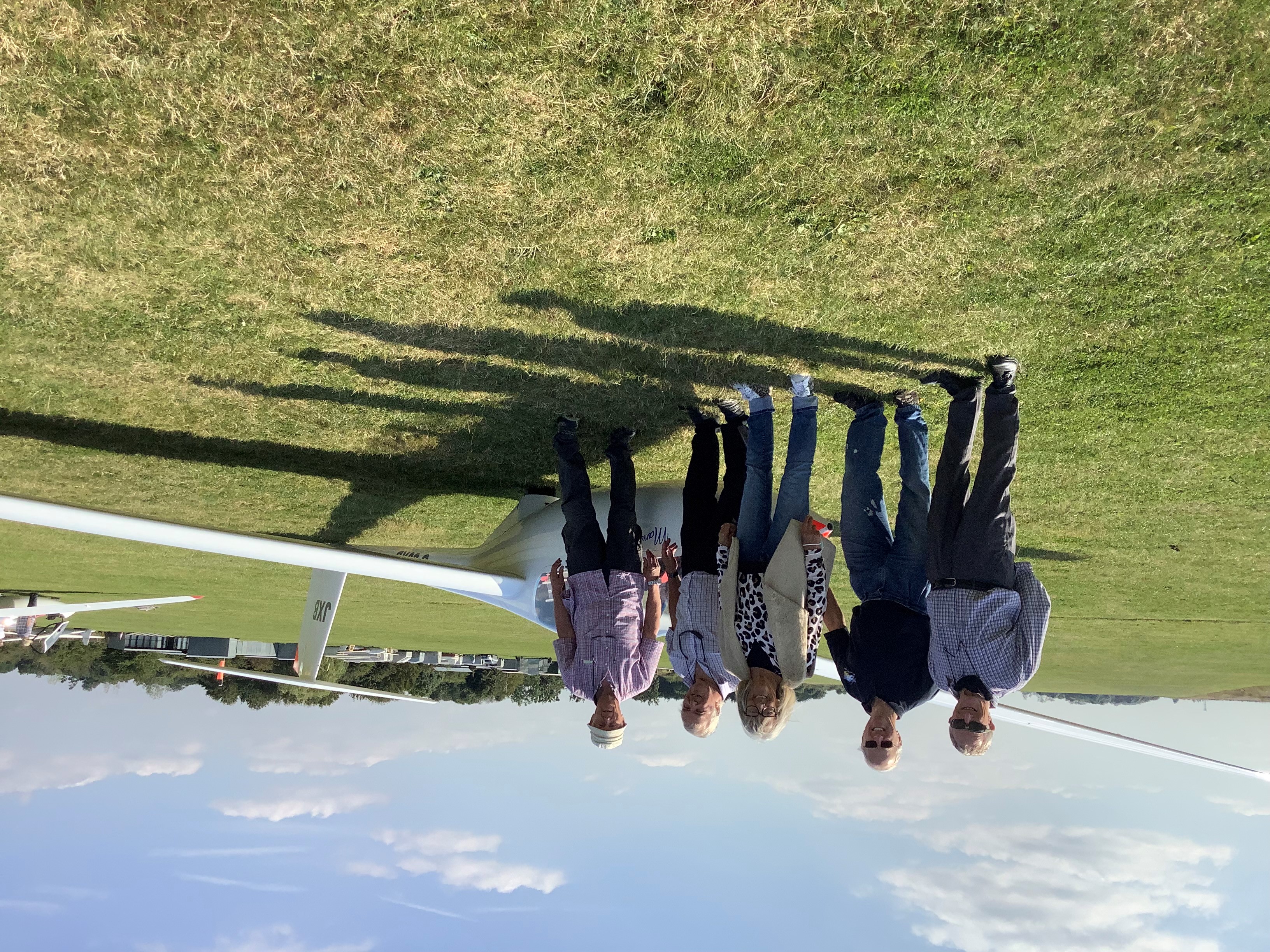 An image of people standing by a glider