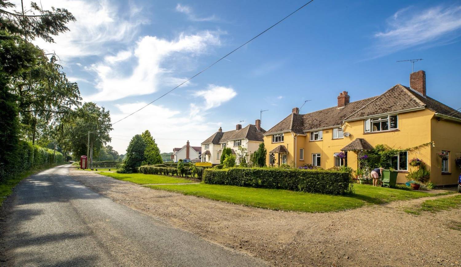 A picture with houses and a road along side them