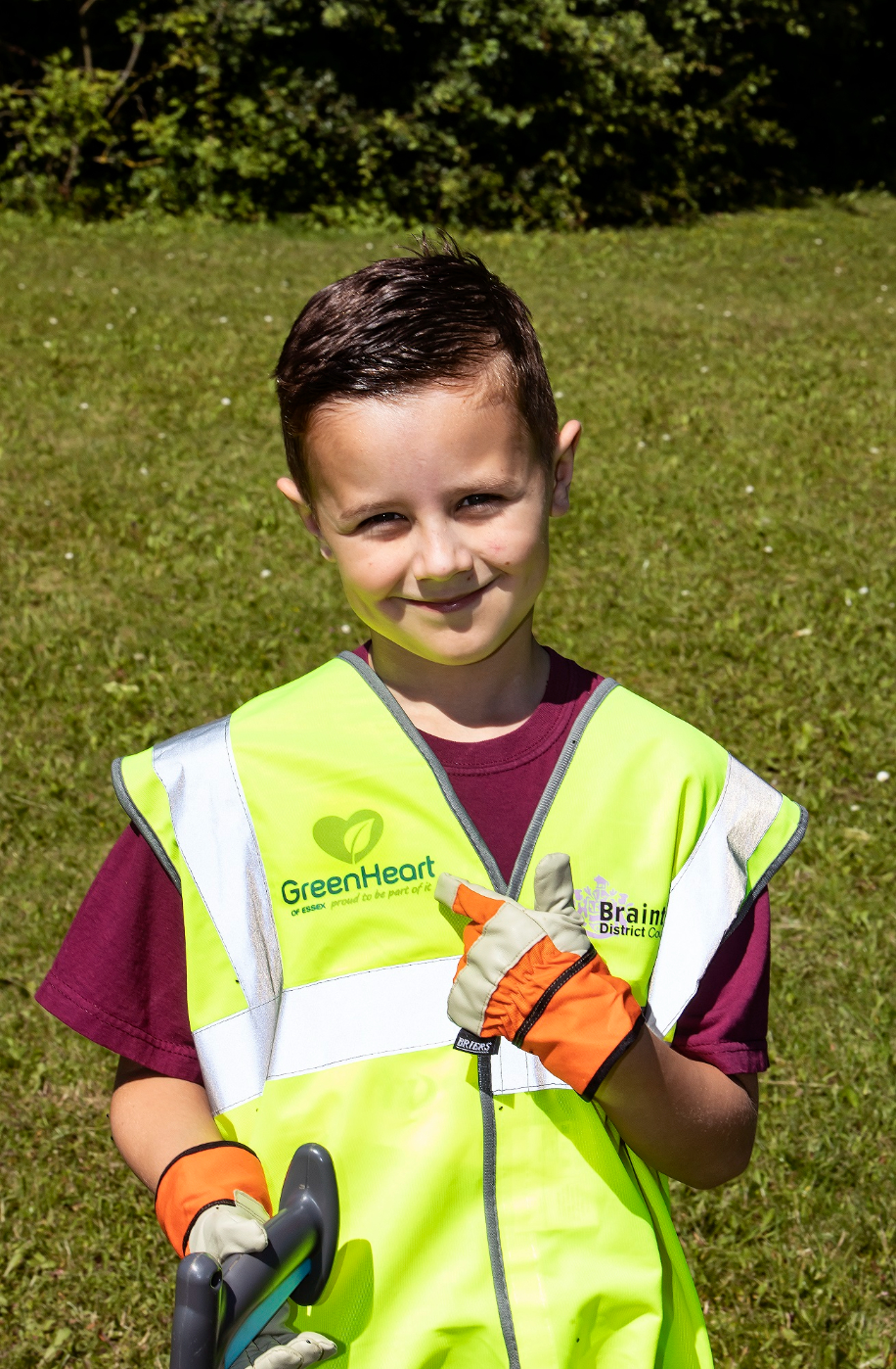 A boy in a Braintree district council high visibility jacket
