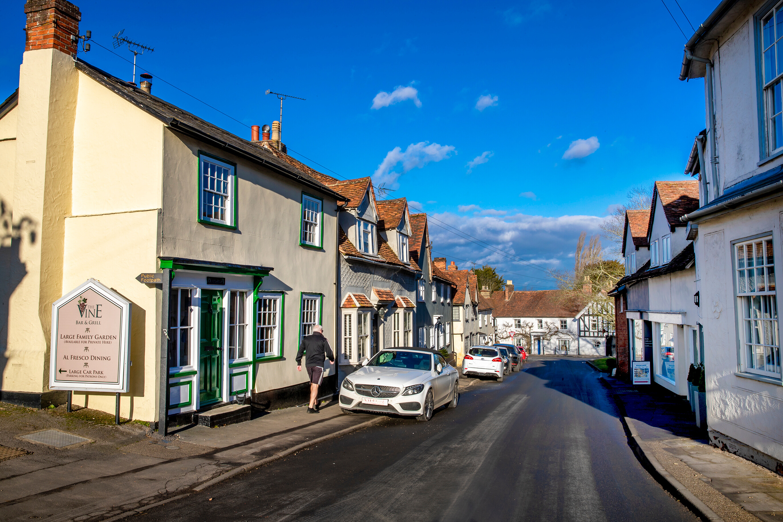 Great bardfield village of houses and a road with cars parked - Image