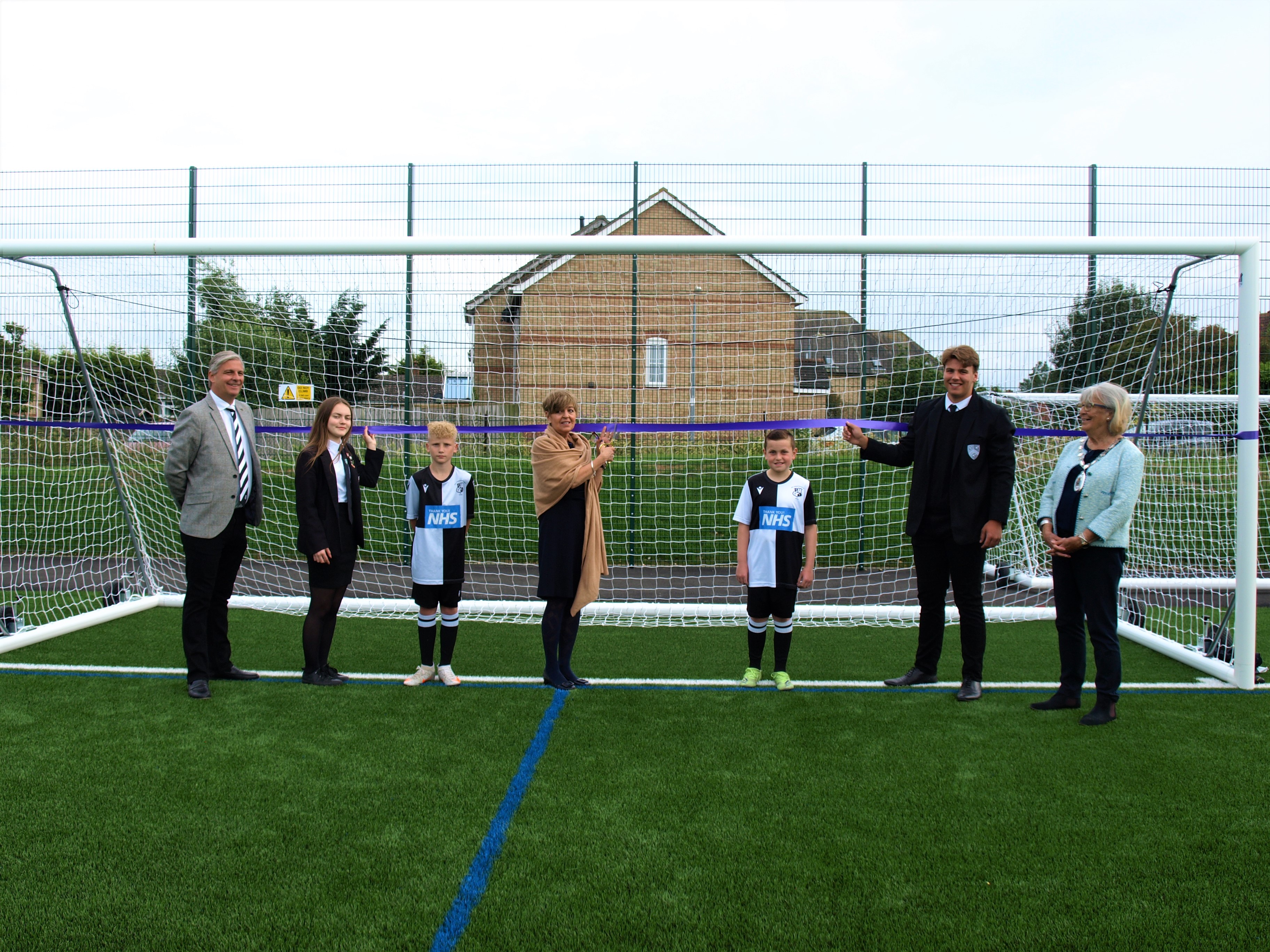 Lorraine Leys cuts ribbon on goal at Halstead artificial football pitch.