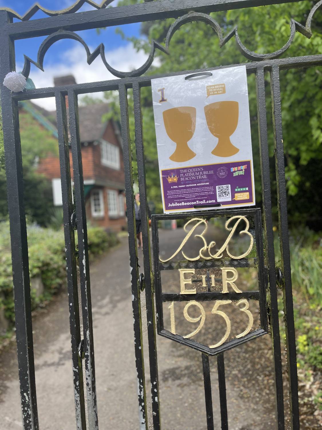 Jubilee trail sign on park gates by Coffee House in the Gardens, Braintree