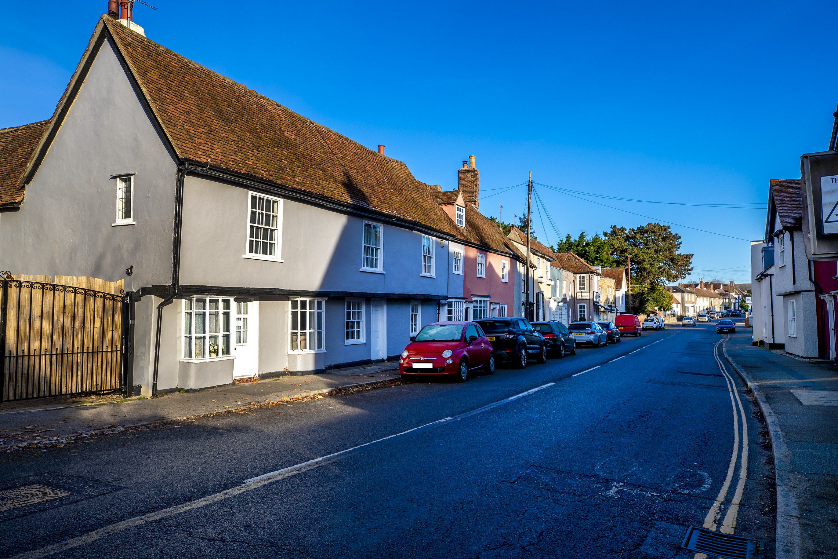 Kelvedon street with cars parked along the road with houses - Image