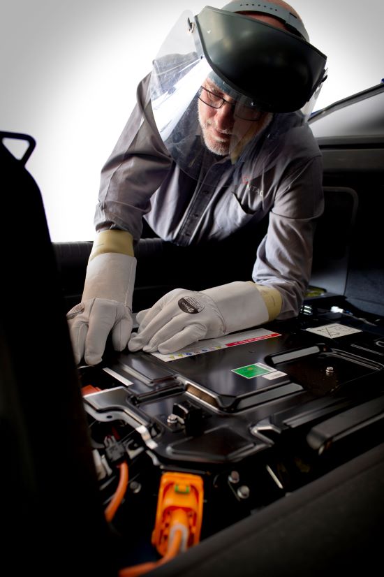Photo of man looking in an engine