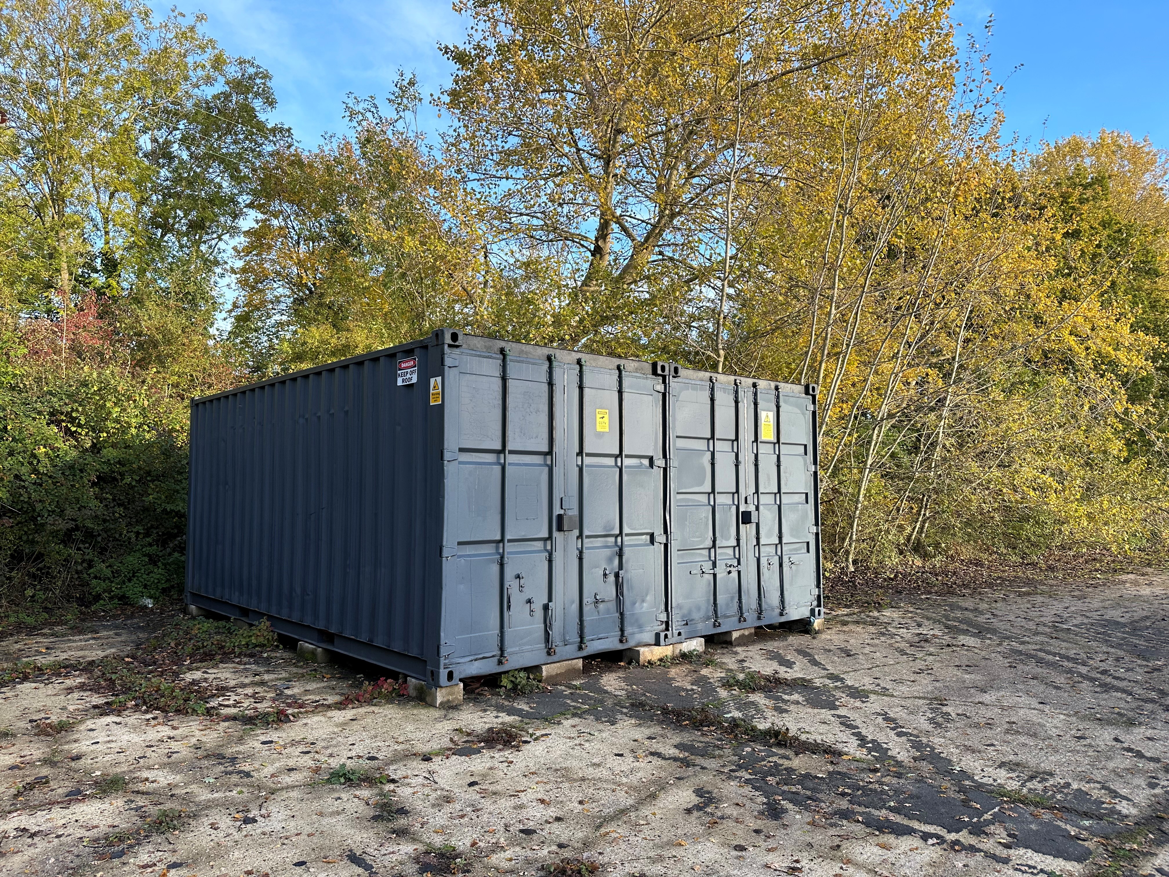 Shipping containers with trees in background