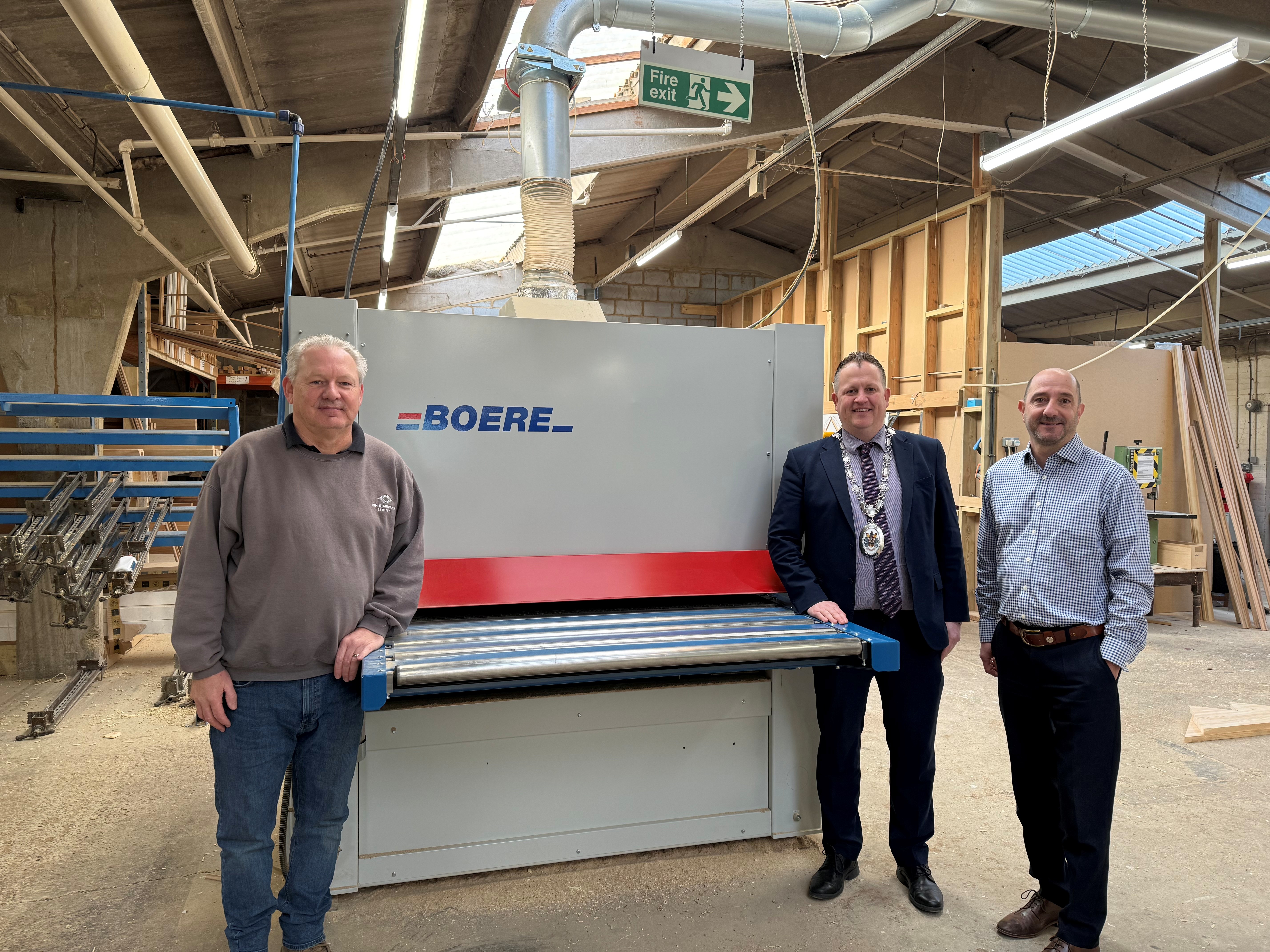 RTH Staircases and Councillors standing by the sanding machine