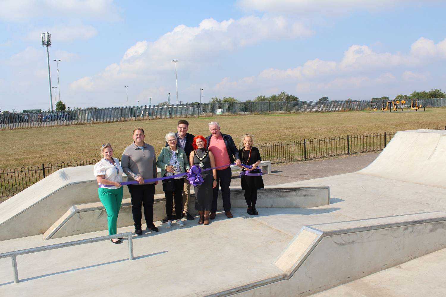 image shows Chairman of Braintree District Council, Councillors and staff with a purple ribbon