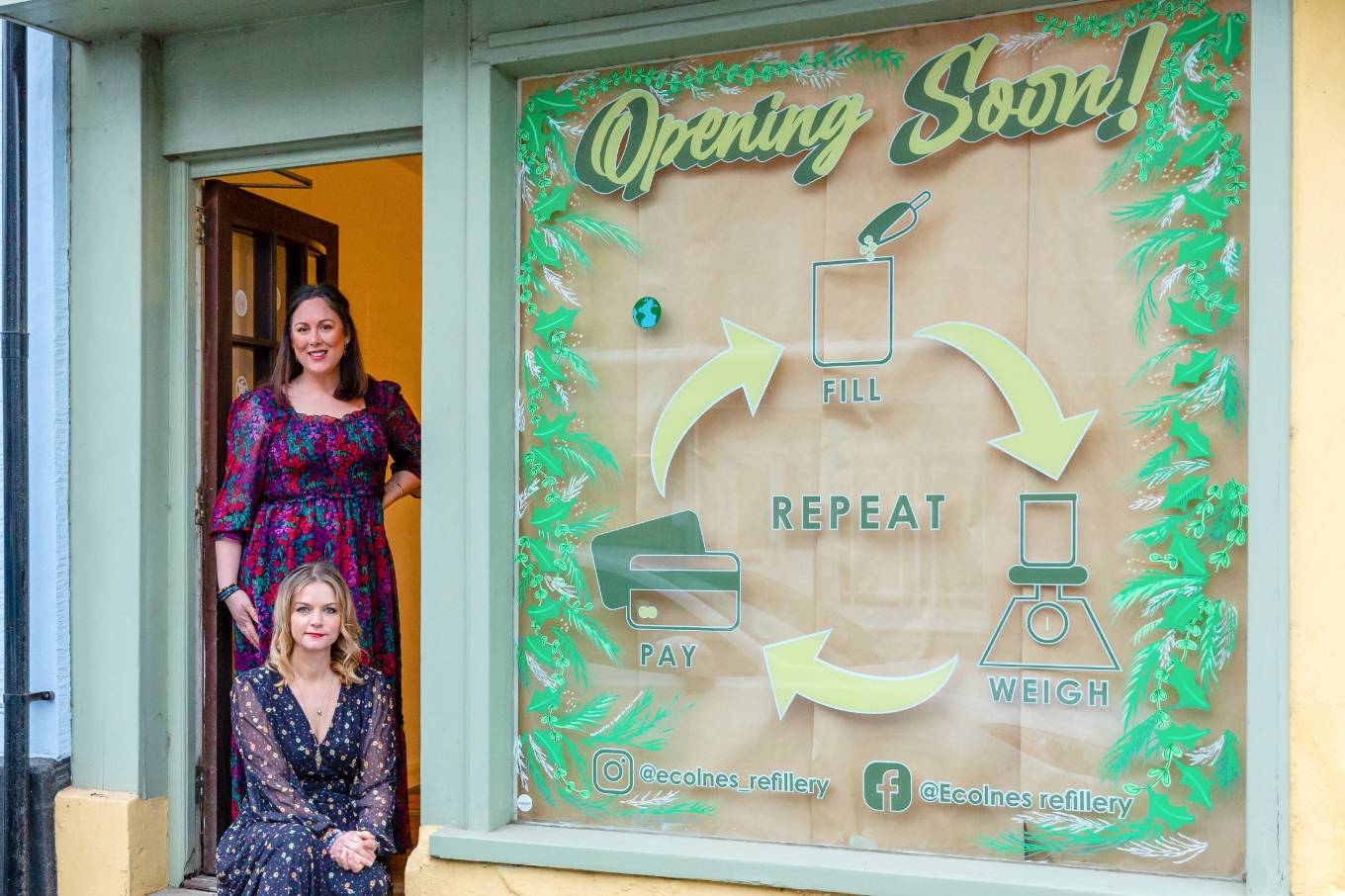 two ladies standing in front a local shop front 