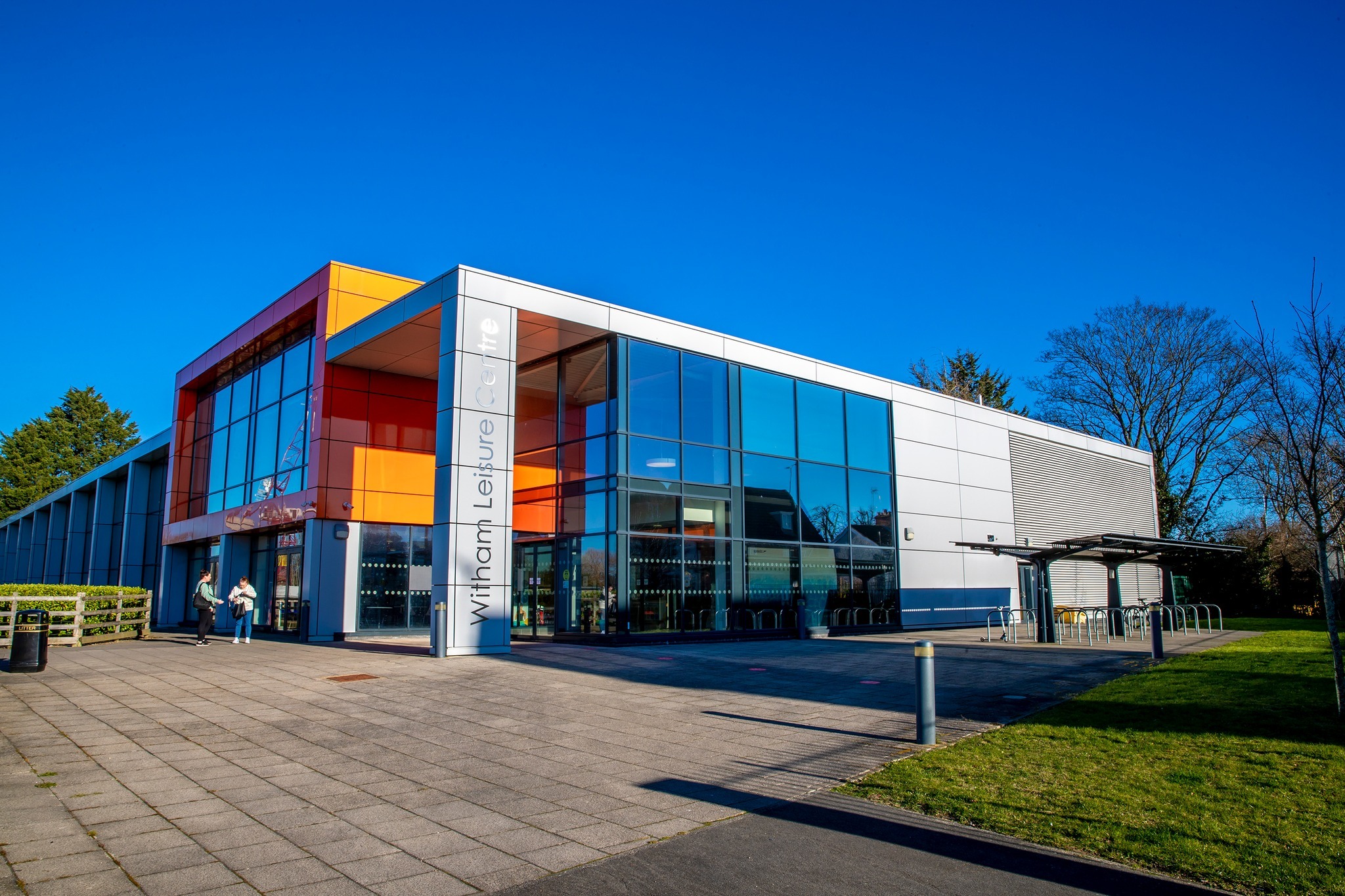 The image shows a large glass building