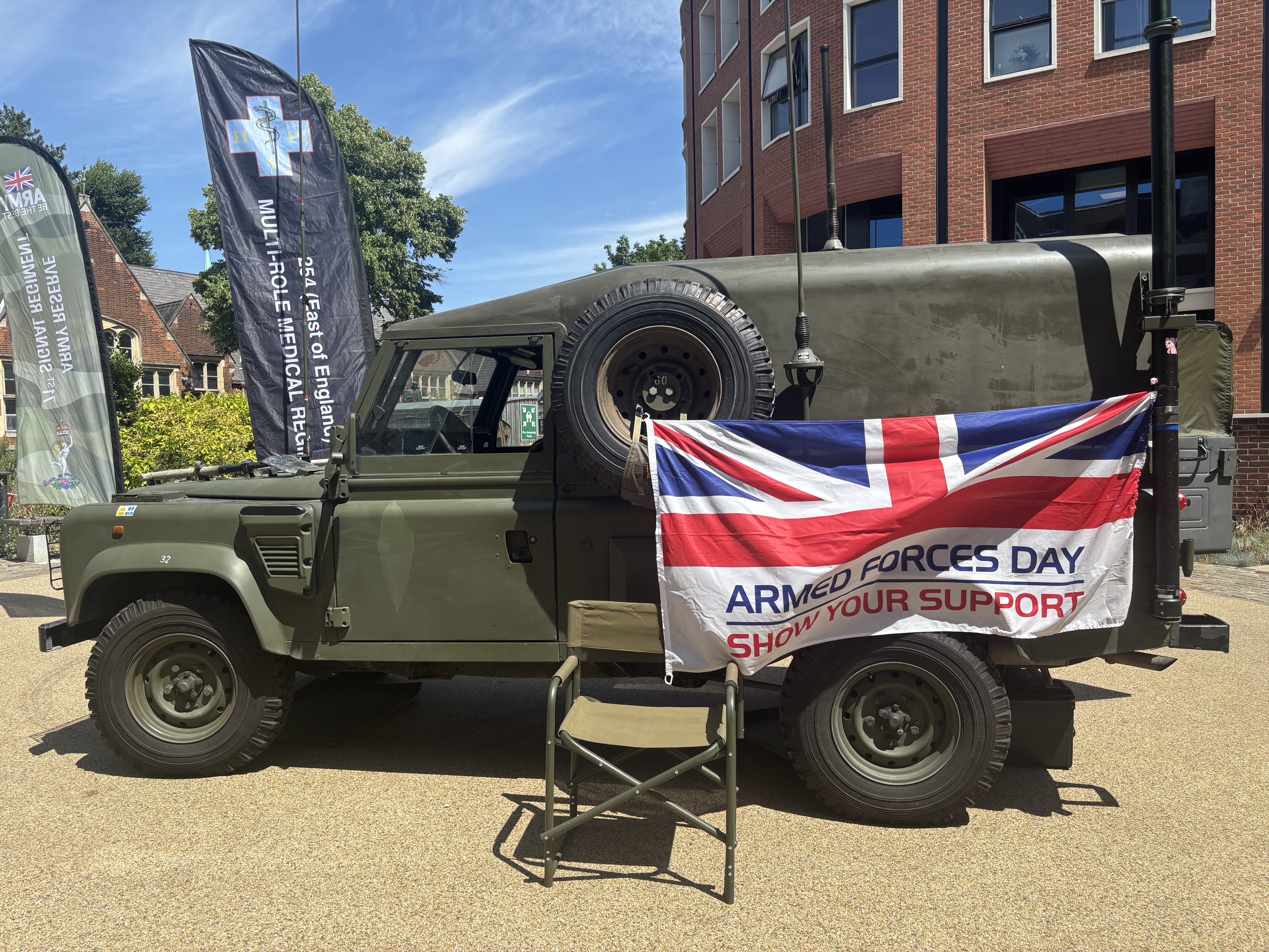 Armed forces day flag hanging on an army vehicle.