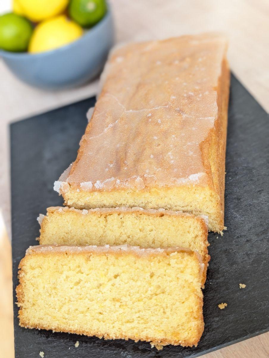picture of a lemon drizzle loaf cake with two slices cut