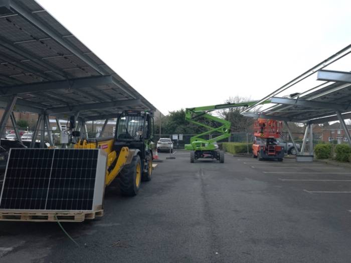 Construction vehicles in witham leisure centre car park, with partially built solar panel canopies